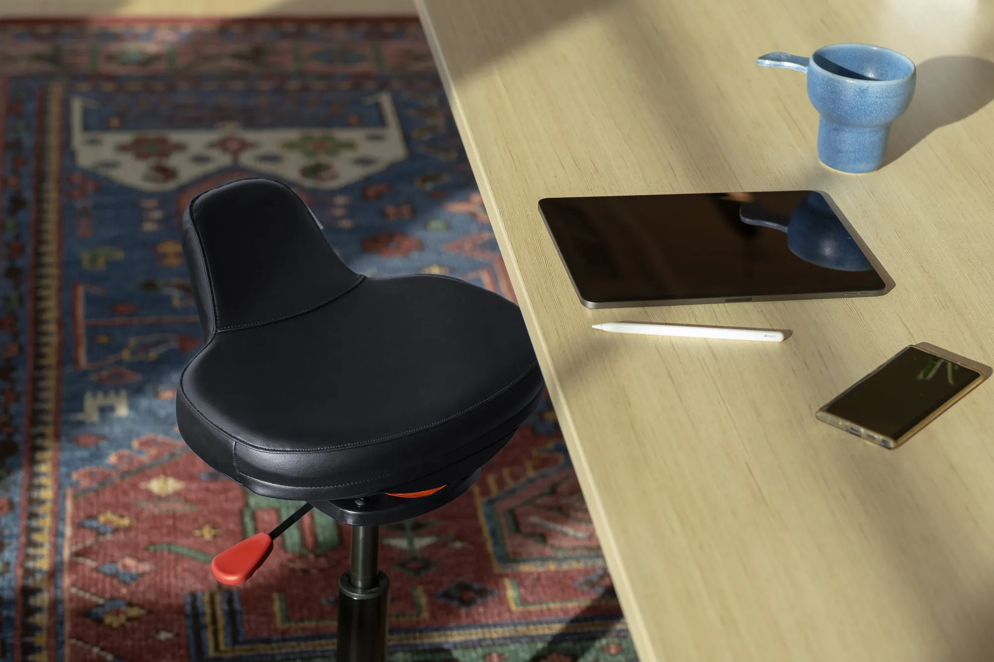 Black Ariel 2.0 at a wooden desk in a home office