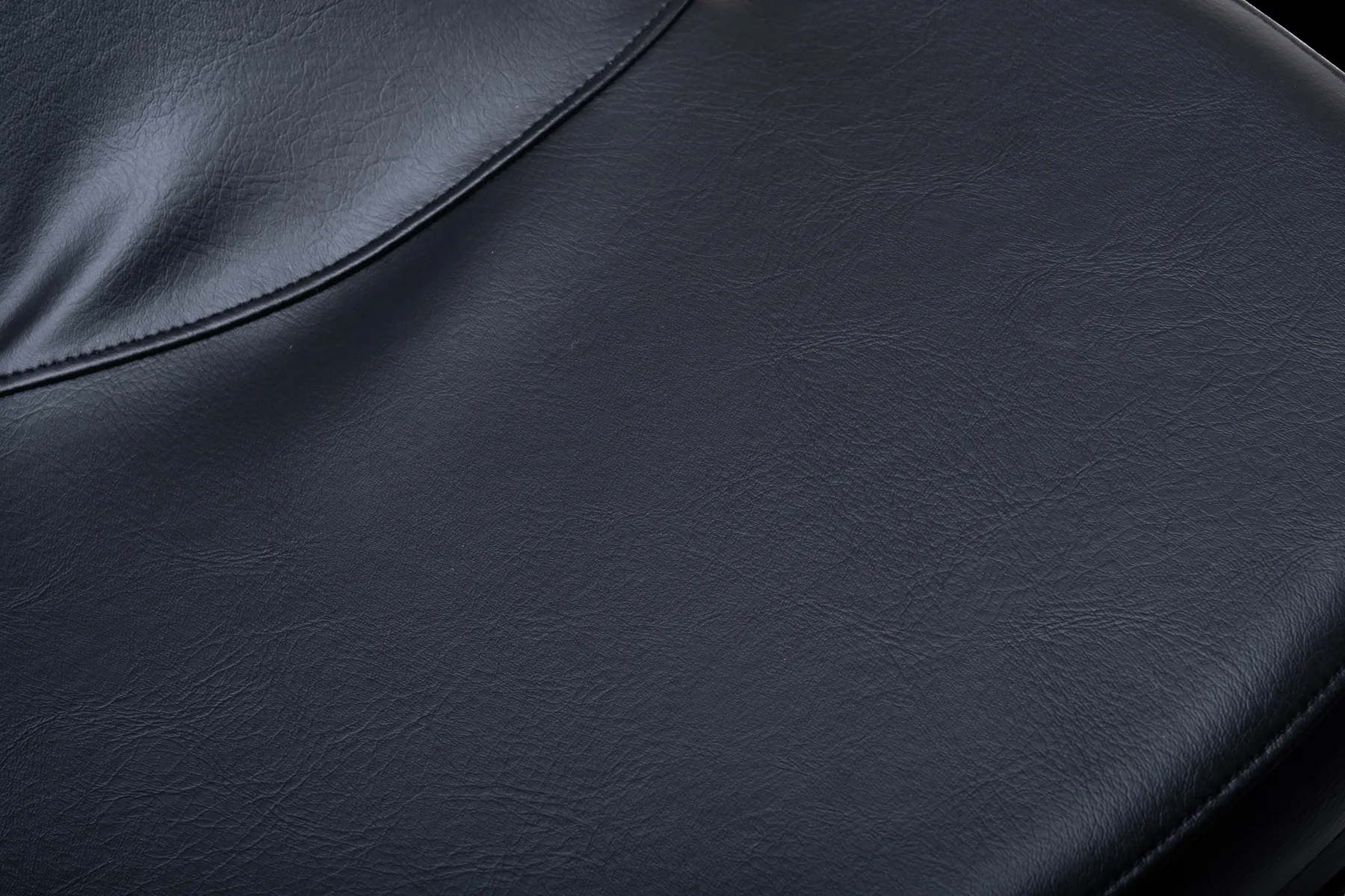 Close-up of the black leather seat stitching