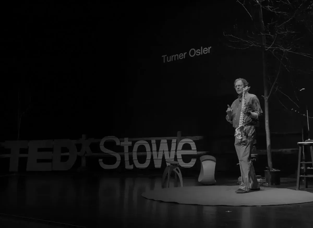 Dr. Turner Osler speaking on stage at TEDx Stowe